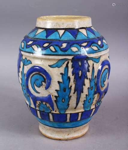 A GOOD PERSIAN BLUE & WHITE POTTERY VASE, decorated with moulded formal floral design, 23cm high.