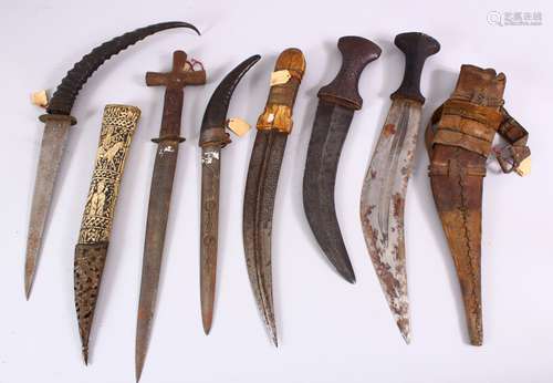 A COLLECTION OF 6 ISLAMIC AND TRIBAL DAGGERS - one with a carved bone sheath, some decorated