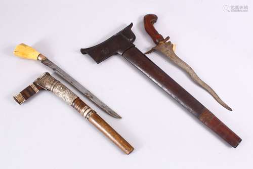 TWO SOUTH ASIAN KRIS DAGGERS - one with a bone handle with a wooden and white metal sheath, 35.5cm ,