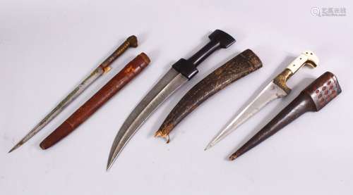 A COLLECTION OF 3 ISLAMIC DAGGERS - One with a bone handle and leather sheath 35cm, one with a