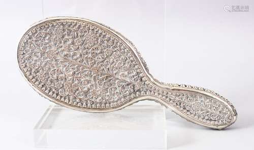 A 19TH CENTURY INDIAN SILVER HAND MIRROR, with floral moulded decoration, 24cm.