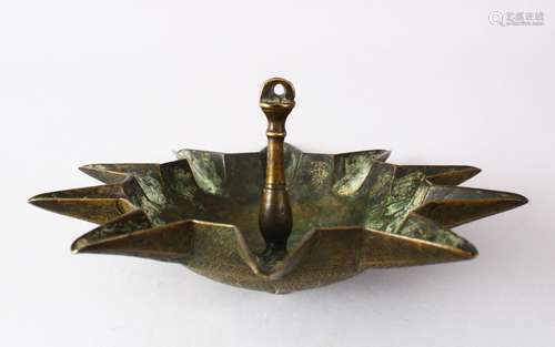 AN UNUSUAL 19TH CENTURY OR EARLIER ISLAMIC BRASS HANGING OIL LAMP, the underside with chased