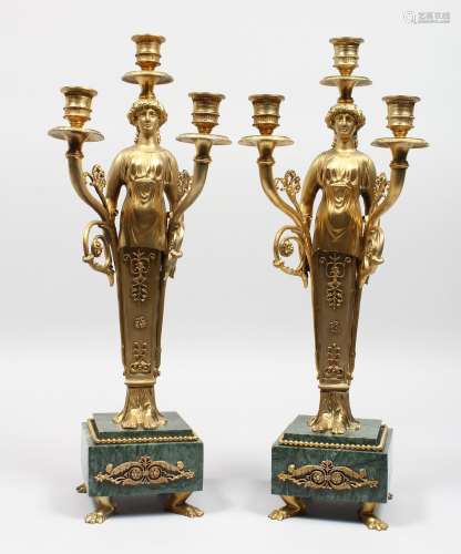 A PAIR OF GILT BRONZE EMPIRE STYLE FIGURAL CANDELABRA, on marble bases.