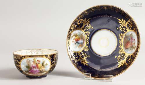 A VIENNA RICH BLUE CUP AND SAUCER with vignettes of figures.