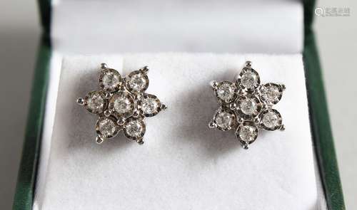 A GOLD PAIR OF 9CT GOLD, DIAMOND DAISY CLUSTER EARRINGS.