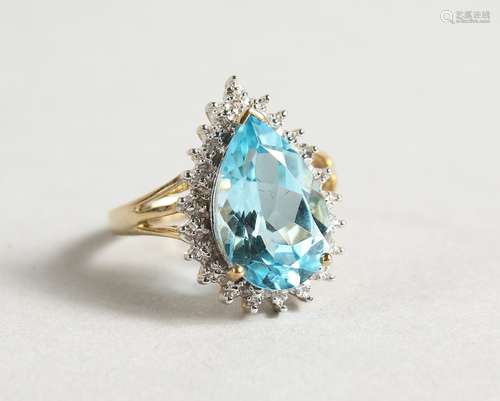 A 9CT GOLD PEAR SHAPED BLUE TOPAZ AND DIAMOND RING.