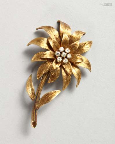 AN 18CT GOLD AND DIAMOND SET FLOWER SHAPED BROOCH. 2ins high.