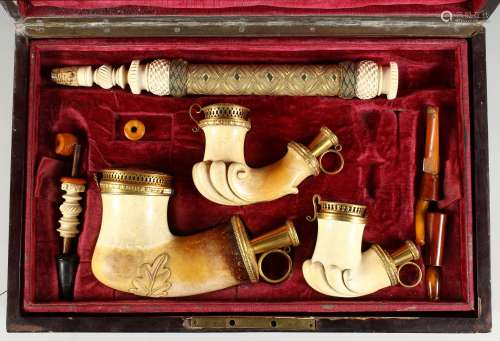 A SUPERB QUALITY SET OF THREE CARVED MEERSCHAUM PIPES of various sizes, mounted in silver gilt,