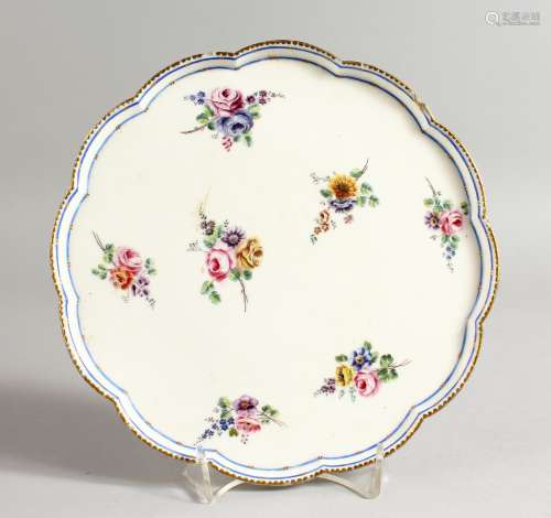 A SEVRES PEDESTAL TAZZA painted with flowers under a single blue line and dentil gilding,
