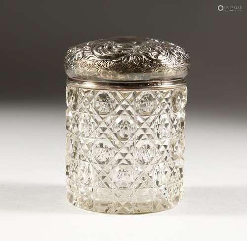 A CUT GLASS DRESSING TABLE JAR, with embossed silver top, Chester 1900. 4ins high.