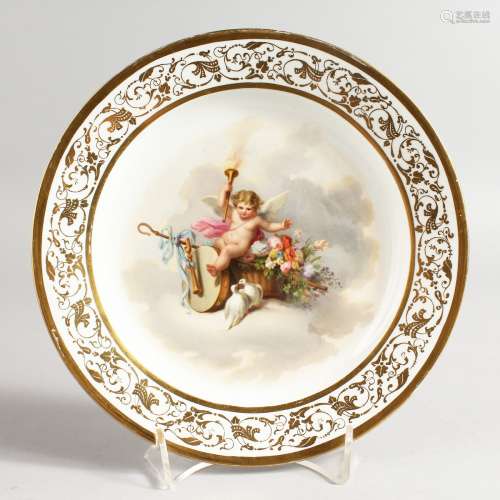 AN ENGLISH DECORATED PARIS PORCELAIN PLATE painted with a winged child in a cloud, seated on a