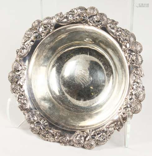 TIFFANY & CO, A STERLING SILVER CIRCULAR BOWL, with floral cast rim. 17ozs. 10ins diameter.