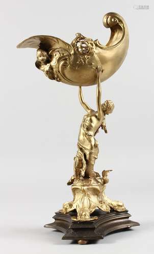 A GILT BRONZE CENTREPIECE modelled as a classical lady holding aloft a conch shell. 16ins high.