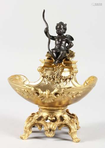 A GILT BRONZE TABLE SALT modelled as a cherub seated on a shell. 7.5ins high.