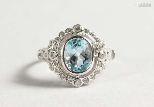 A SILVER AND BLUE TOPAZ RING.