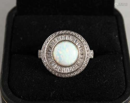 A SILVER AND GILSON OPAL RING.