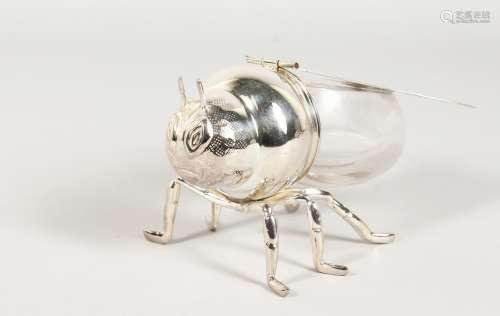 A SILVER PLATE AND GLASS BEE SHAPED HONEY JAR.