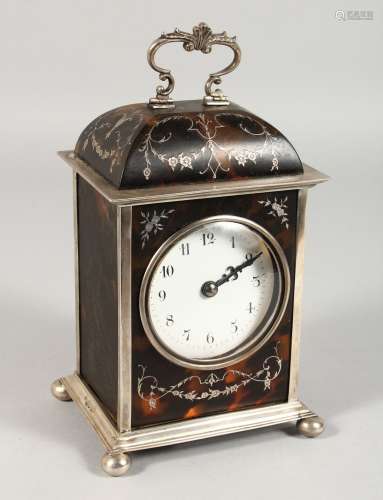 A GOOD SILVER AND TORTOISESHELL CLOCK with carrying handle on ball feet. 8ins high. London 1911.