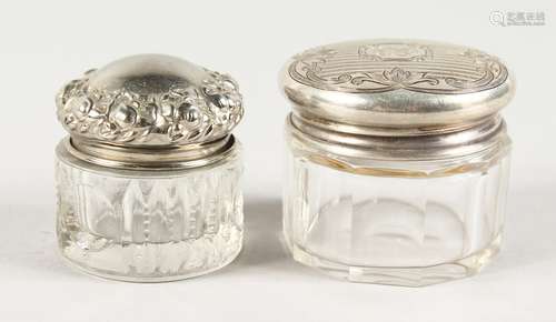 TWO SMALL CUT GLASS JARS with silver lids.