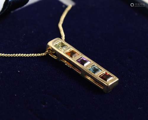 A 9CT GOLD PENDANT WITH PERIDOT, CITRINE, AMETHYST, BLUE TOPAZ AND GARNET, on a chain.