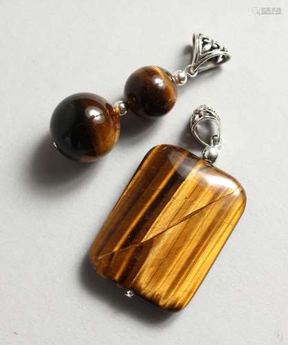 TWO SILVER AND TIGER'S EYE PENDANTS.