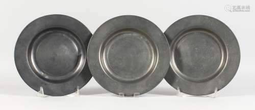 THREE EARLY PEWTER CIRCULAR PLATES, stamped LONDON. 7.75ins diameter.