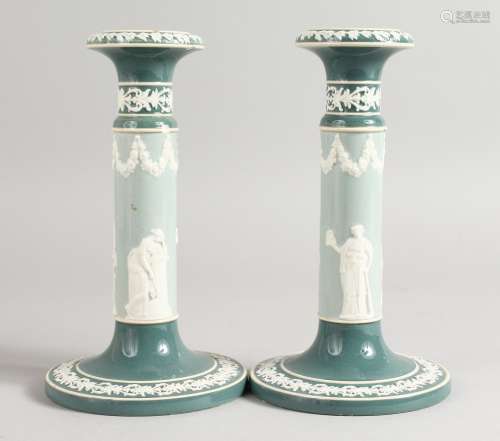 A PAIR OF CARLTON WARE JASPER CIRCULAR CANDLESTICKS on circular bases. Printed mark. 7.5ins high.