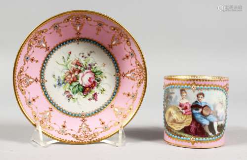 A GOOD SEVRES PINK GROUND CUP AND SAUCER, the cup painted with a boy with guitar, a girl by his side