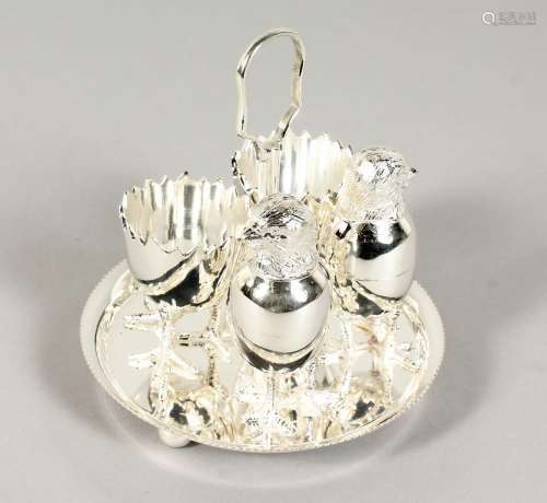 A SILVER PLATED DOUBLE EGG CRUET with chicken salt and pepper.