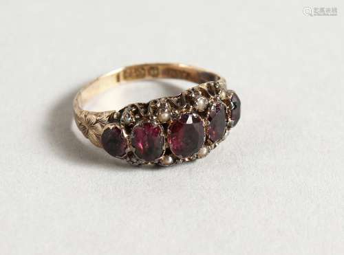 AN 18CT RUBY AND SEED PEARL SET FIVE-STONE RING.