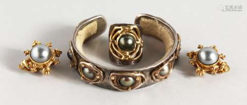 A GOLD, SILVER AND PEARL SET, comprising bangle, ring and earrings.