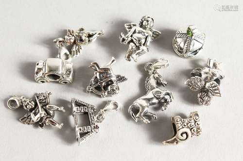 TEN SILVER CHARMS.