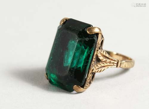 A 9CT GOLD AND GREEN-STONE RING.