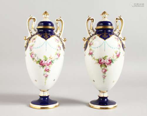 AN EARLY 20TH CENTURY MINTON PAIR OF TWO-HANDLED PEDESTAL OVOID VASES painted by Dudley, signed,