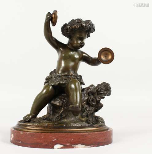 AFTER CLODION (1738-1814) FRENCH A GOOD BRONZE OF A SEATED CUPID playing cymbals, on a circular
