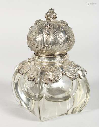 A GLASS INKWELL WITH HINGED SILVER TOP. 6ins high.