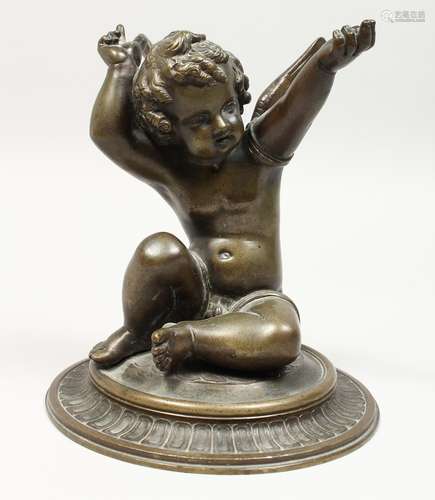 A GOOD BRONZE WINGED CUPID on a circular base. 7ins high.