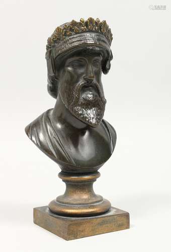 A SMALL BRONZE BUST on a square base. 7ins high.