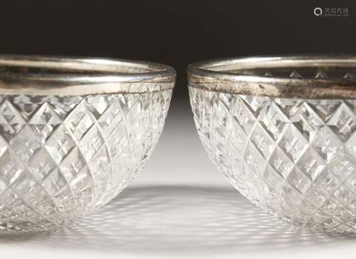 A PAIR OF SILVER BANDED CIRCULAR CUT GLASS BOWLS. 4ins diameter. Birmingham 1945.