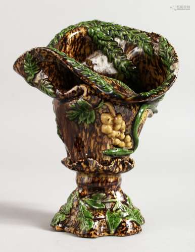 A SMALL MAJOLICA BROWN GLAZED VASE with fruiting vines. 7ins high.