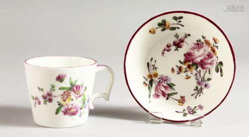 AN 18TH CENTURY MENNECY CUP AND SAUCER painted with flowers.