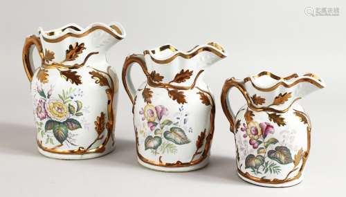 A GARNITURE OF THREE LUSTRE JUGS. 7ins, 6.5ins and 5ins high.