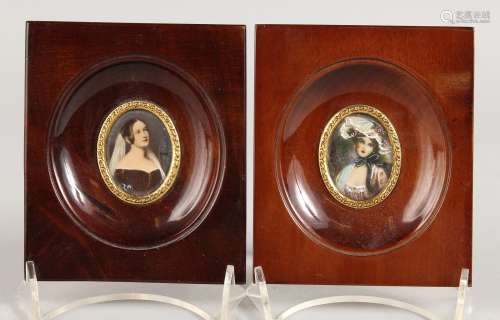 A PAIR OF OVAL PORTRAIT MINIATURES OF YOUNG LADIES in wooden frames. 1.5ins x 1ins.