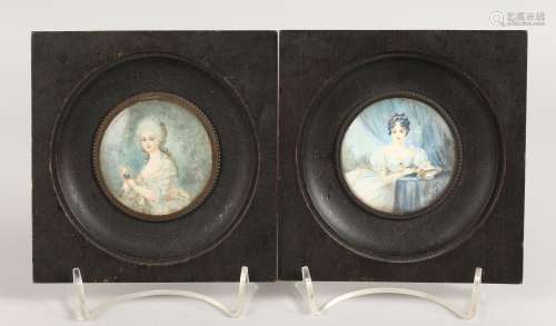 A PAIR OF CIRCULAR PORTRAIT MINIATURES OF YOUNG LADIES in wooden frames. 2.25ins diameter.