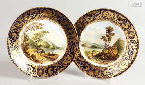 A LATE 19TH CENTURY DERBY PAIR OF WALL PLATES with hanging holes, painted with named scenes.