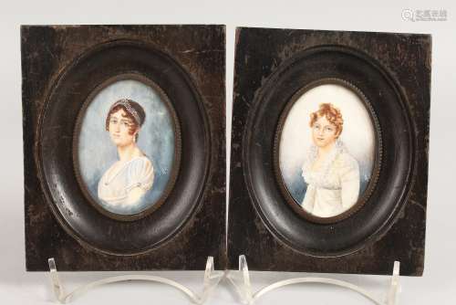A PAIR OF OVAL PORTRAIT MINIATURES in wooden frames. 3ins x 2ins. Monogrammed.