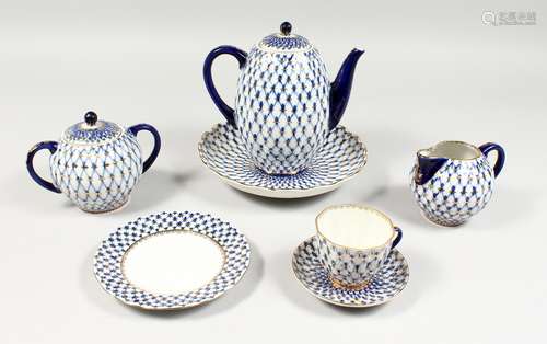 A RUSSIAN PORCELAIN BLUE AND GILT TEA SET, comprising teapot, sugar basin and cover, milk jug, six