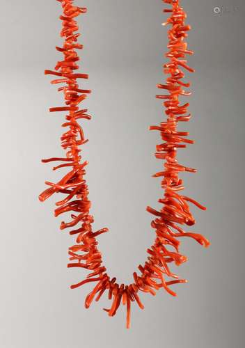 A CORAL NECKLACE with gold clasp.