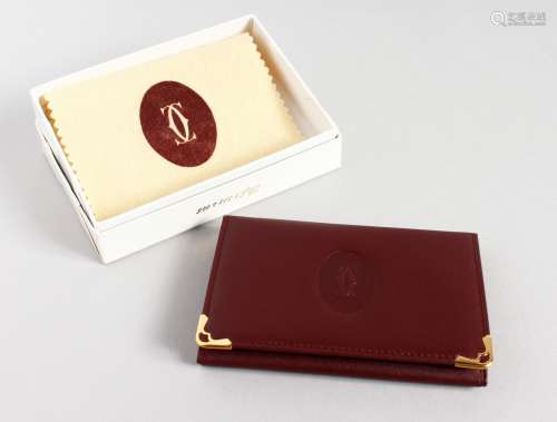 A CARTIER LEATHER WALLET in a Cartier white box.