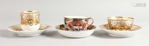 A SPODE COFFEE CUP AND SAUCER AND A TEACUP AND SAUCER superbly decorated in raised gold in Empire